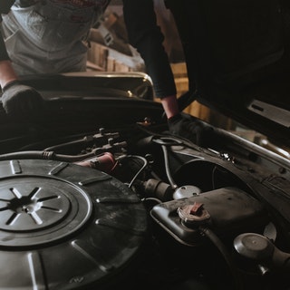 mechanic inspecting engine of an american car
